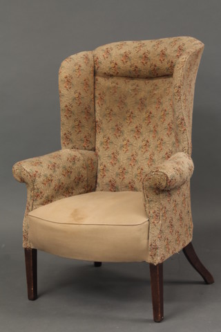 A Georgian mahogany winged tub back chair raised on square tapering supports