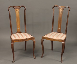 A pair of Edwardian inlaid mahogany slat back bedroom chairs with upholstered drop in seats, raised on cabriole supports