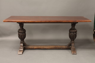 An oak refectory dining table raised on a later base with bulbous turned supports with H framed stretcher 70"