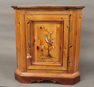 A painted pine corner cabinet enclosed by panelled doors raised on bracket feet 34"