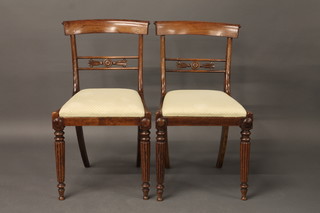 A set of 4 19th Century rosewood bar back dining chairs with  carved mid rails and upholstered drop in seats, raised on turned  and fluted supports