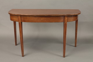 A 19th Century mahogany demi-lune table raised on square  tapering supports 48"