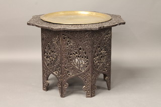 An Eastern pierced carved hardwood folding table with benares brass tray 30"