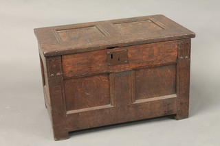 A 17th/18th Century coffer of panelled construction with hinged lid, the interior fitted a candle box 30"