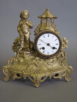 A 19th Century French striking mantel clock with enamelled dial contained in a gilt painted spelter case decorated a standing boy