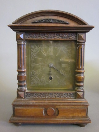 A Continental 8 day mantel clock with 5" gilt dial and Roman numerals contained in a walnut arch shaped case