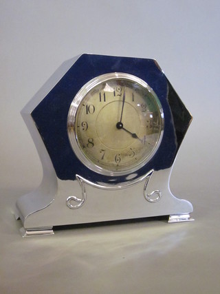 An Art Nouveau bedroom timepiece with silvered dial and Arabic numerals contained in a shaped chrome case, raised on bracket  feet 7"  ILLUSTRATED