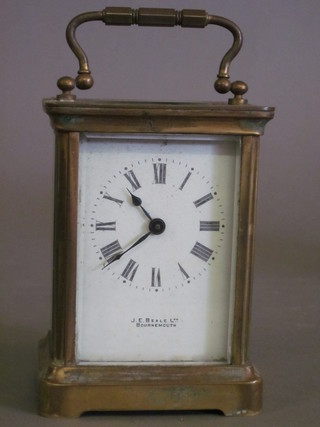 A 19th Century French carriage clock with enamelled dial and Roman numerals, the dial marked J E Beale Ltd Bournemouth,  complete with leather carrying case