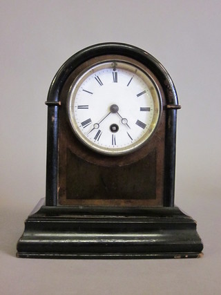 A Victorian 8 day mantel clock with enamelled dial and Roman  numerals contained in a walnut arched case  ILLUSTRATED