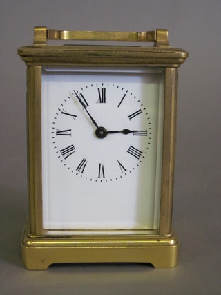 A 19th Century French carriage clock with enamelled dial and Roman numerals contained in a gilt metal case