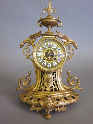 A 19th Century French striking 8 day mantel clock with  enamelled dial contained in a gilt painted ormolu case, surmounted by lidded urn, 1 foot and pendulum missing,