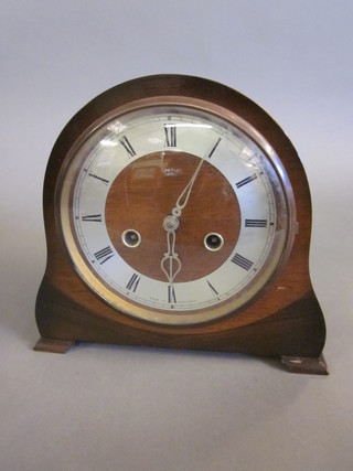 A 1950's Smiths 8 day striking mantel clock with silvered dial and  Roman numerals contained in an oak arch shaped case
