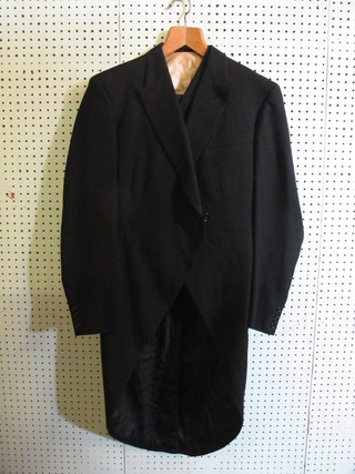 A Gentleman's black tail coat by Harrods together with a  waistcoat and pair of striped trousers