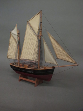A wooden model of a fishing smack 14"