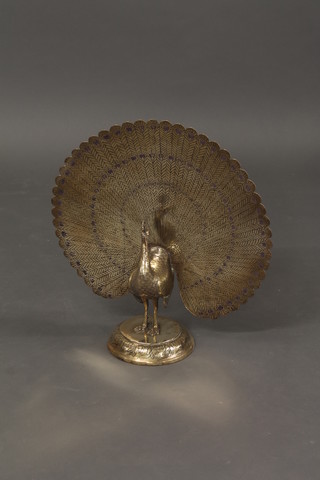 An Eastern brass figure of a standing peacock 20"
