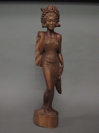 A Balinese carved hardwood figure of a standing lady 24"