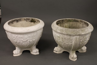 A pair of white painted circular garden urns with leaf decoration, raised on 4 hoof feet 24"