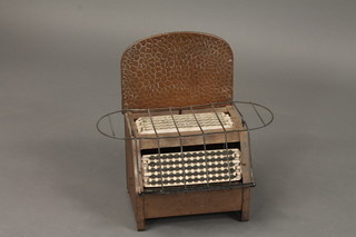 A 1930's Belling electric fire with planished back, for decorative  purposes only