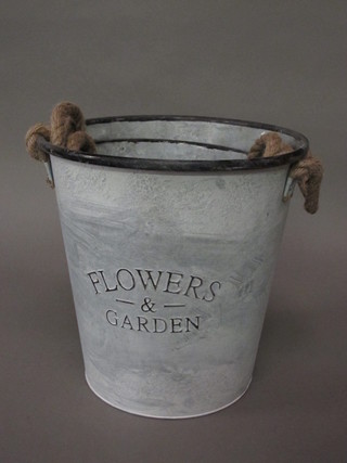 3 cylindrical embossed metal pails marked Flowers and Garden