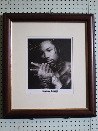 A framed black and white signed photograph of Lennox Lewis 9"  x 7"