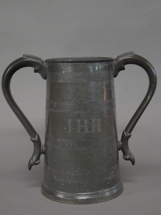 A twin handled pewter loving cup, the base marked J H Howard  Horse & Groom Ramsgate 9"
