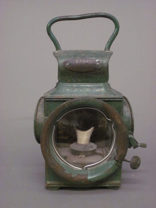 A green metal cart lamp by Powell & Hanmer