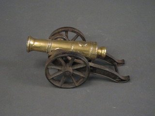 A brass cannon with 10" barrel, raised on an iron carriage   ILLUSTRATED