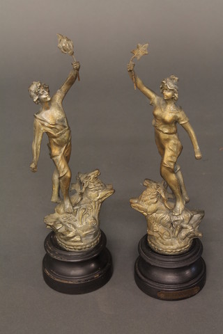A pair of spelter figures in the form of standing ladies with torches 13"