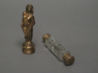 A 19th Century gilt metal seal in the form of a standing lady 4" and a glass double ended scent bottle