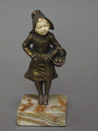 An Art Deco bronze and ivory figure of a standing girl with basket, raised on a marble base 7"
