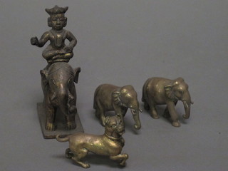 An Eastern bronze figure of an elephant with Deity, 2 gilt metal figures of elephants and a figure of a dog