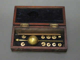 A Sykes hydrometer with various weights, ruler, no magnifying  glass contained in a rosewood case
