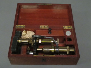A student's single pillar microscope, boxed