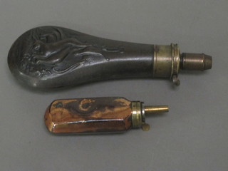 An embossed metal powder flask and 1 other