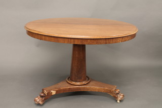 A William IV circular snap top breakfast table, raised on a turned  column with tripod base and paw feet 42"