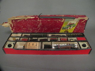 A Trix twin rail train set comprising 2 transformers and various items of rolling stock