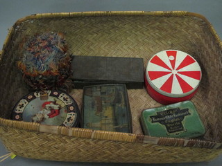 A wicker laundry basket containing various tins with nursery  games etc