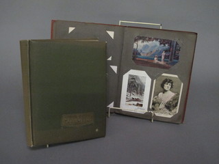 A green album containing 70 postcards 1900-1930 and 1 other  containing 52