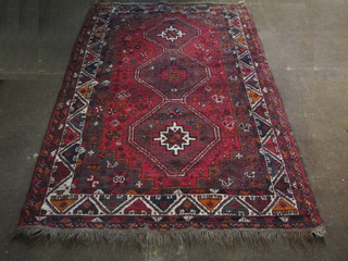 A red ground Persian Shiraz rug with 3 octagons to the centre 91" x 60"