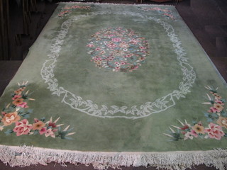 A green floral patterned Chinese carpet, some moth to the sides,