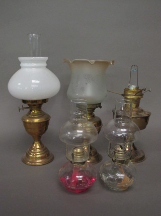 2 glass oil lamps and 3 brassed oil lamps