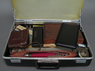 A brief case containing a metal ink well, spinning shuttle, camera and various drawing instruments
The larger set of cased instruments shown in the photograph have been withdrawn from this lot 