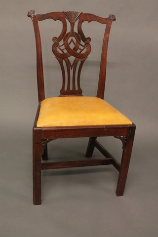 A Chippendale style mahogany slat back dining chair with upholstered drop in seat, raised on square supports