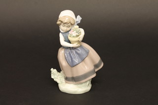 A Lladro figure of a standing girl with pot plant, base marked 5223, 6"