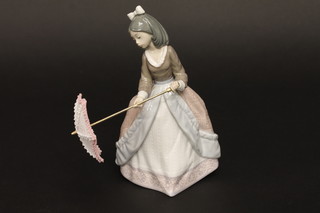 A Lladro figure of a standing lady with parasol, based marked 5210, 7"