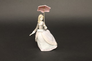 A Lladro figure of a standing lady with parasol, base marked 5211 8"