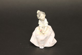 A Lladro figure of a seated girl with rose, number 5.372, 4",  boxed