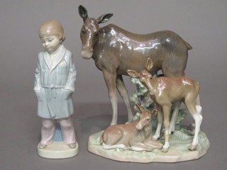 A Lladro figure of a standing boy with dressing gown 8" and a 1 other Lladro figure group of a standing donkey and foals, leg on  foal f,