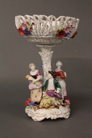 A handsome Continental porcelain table centre piece/comport  supported by 4 period figures, the pierced basket with floral  decoration and the base with floral encrusted decoration 20"   ILLUSTRATED