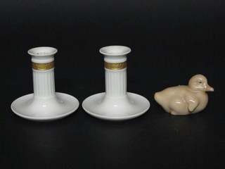 A Danish figure of a duckling, the base marked B&G 3" and a pair of Royal Copenhagen stub shaped candlesticks, bases marked  Den Danfke Landmands Bank 3 1/2"